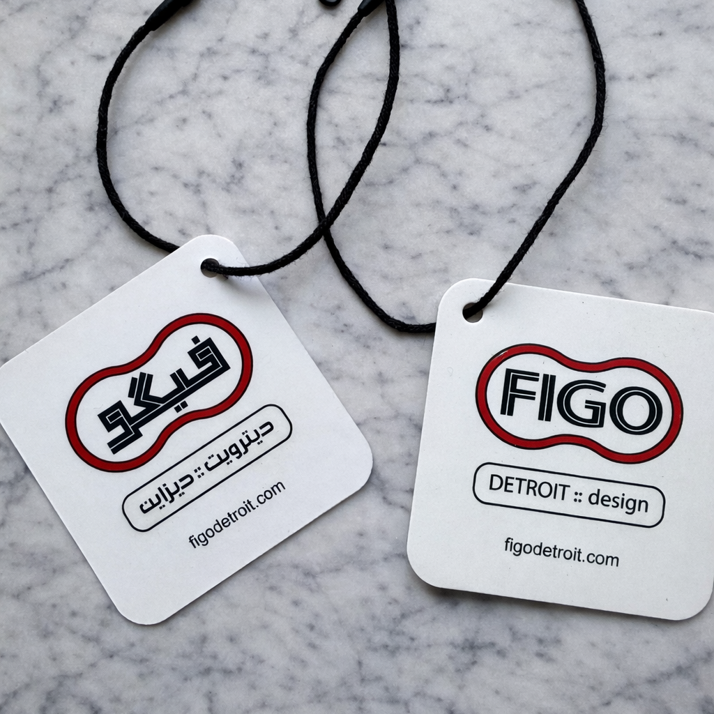 Two black lanyards with 'FIGO DETROIT' branding on white cards against a marble background.