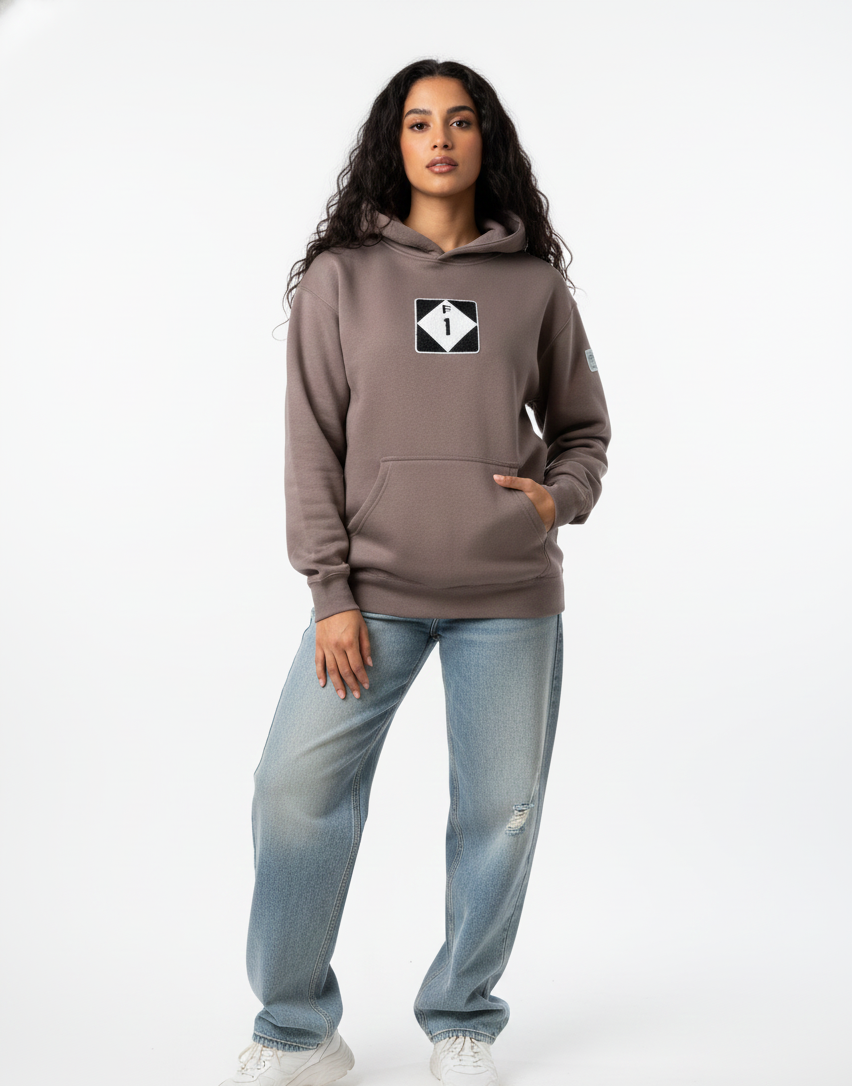 Person wearing a brown hoodie with a logo on a white background